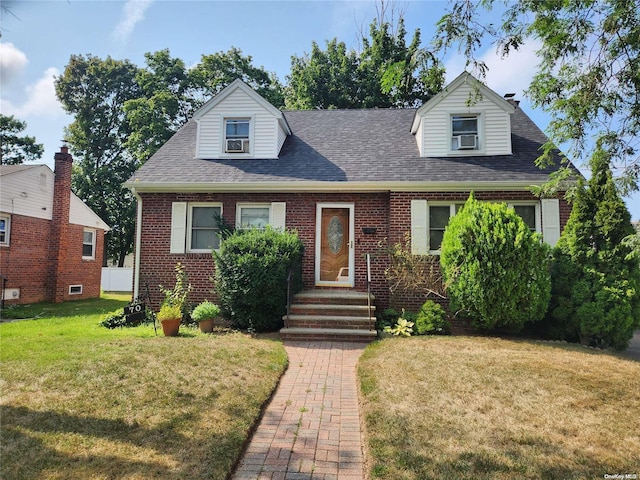 cape cod home featuring a front lawn