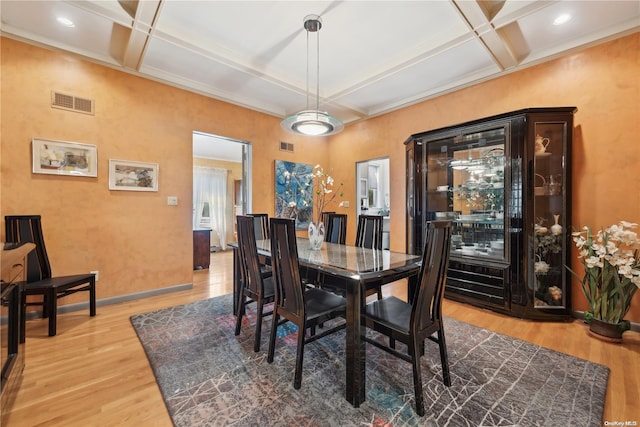 dining room featuring hardwood / wood-style flooring, beam ceiling, and coffered ceiling