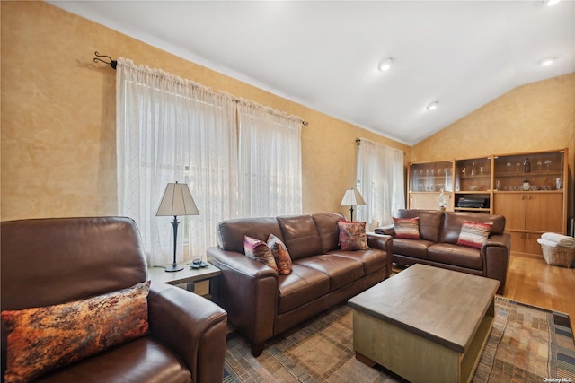 living room featuring vaulted ceiling and hardwood / wood-style flooring