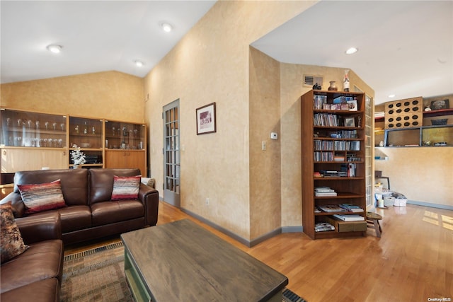 living room with hardwood / wood-style floors and lofted ceiling