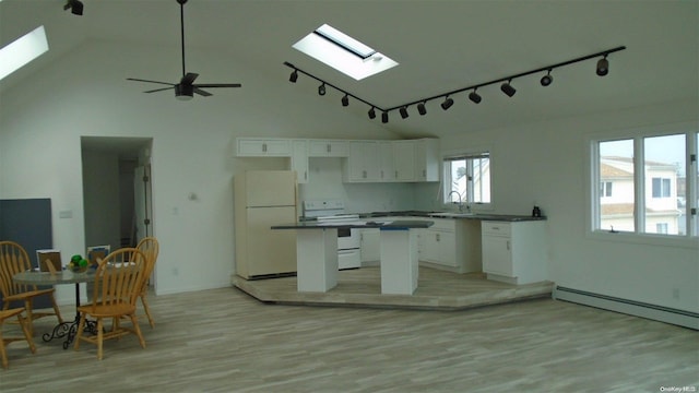 kitchen with white cabinets, white appliances, a skylight, and high vaulted ceiling