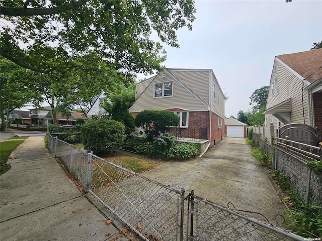 view of side of property featuring a garage and an outbuilding