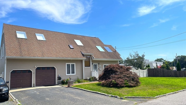 view of front of home with a garage and a front lawn