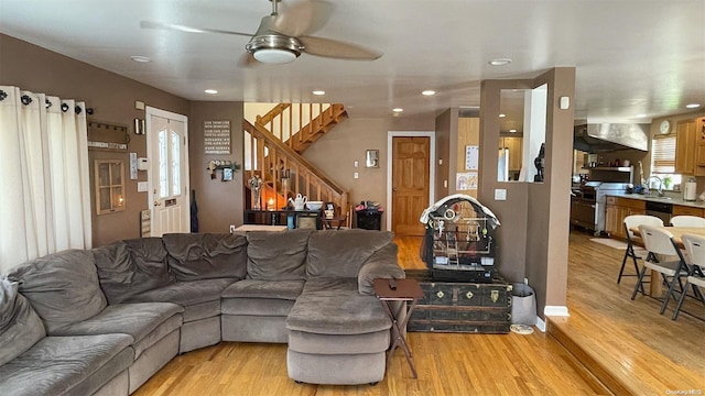 living room featuring light hardwood / wood-style floors and ceiling fan