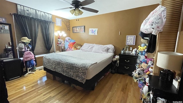 bedroom with ceiling fan and light hardwood / wood-style floors