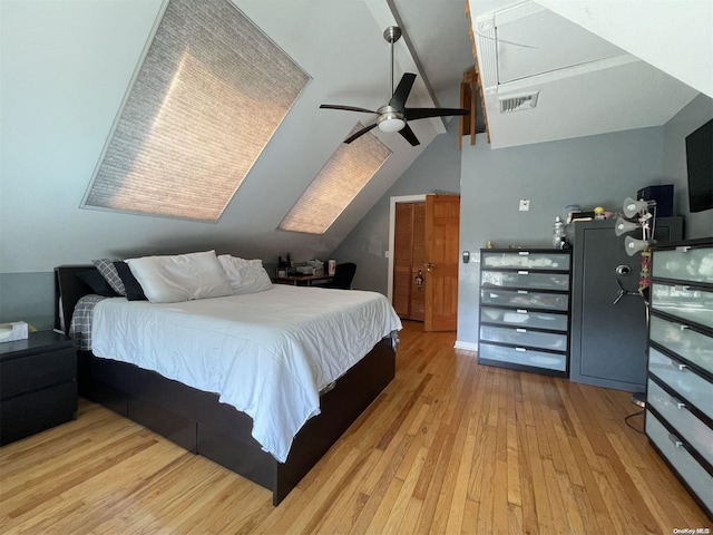 bedroom with vaulted ceiling with beams, ceiling fan, and light wood-type flooring