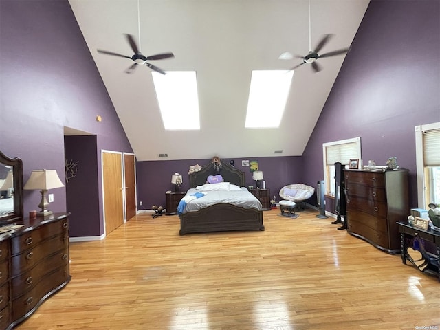 bedroom with light wood-type flooring, high vaulted ceiling, and ceiling fan