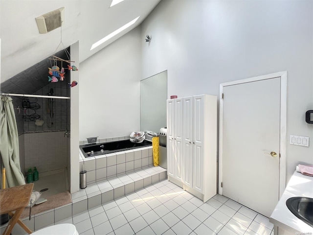 bathroom with tile patterned floors, vanity, plus walk in shower, and high vaulted ceiling