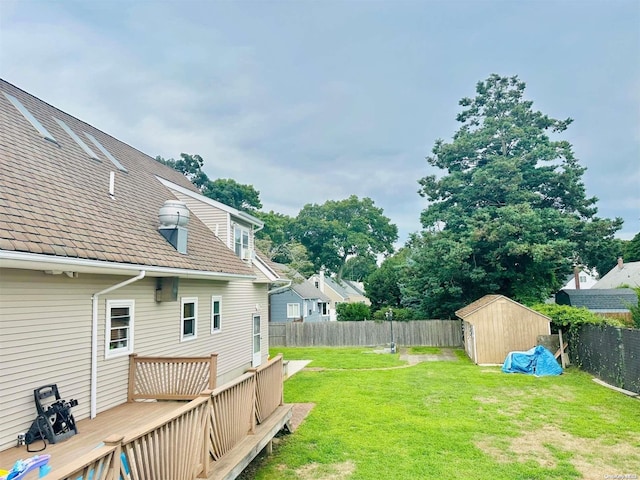 view of yard with a storage unit and a deck