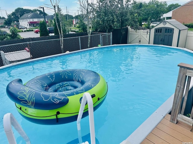 view of pool featuring a shed