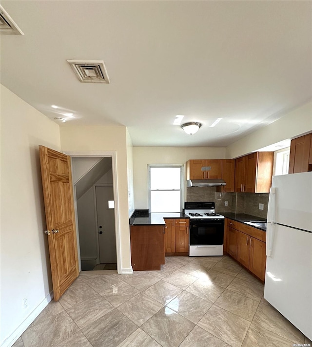 kitchen with decorative backsplash and white appliances