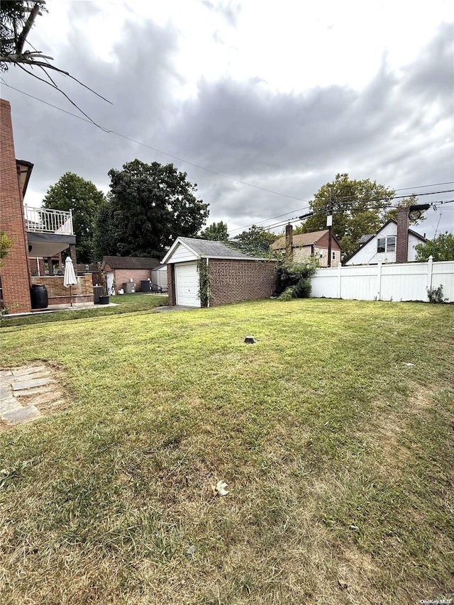 view of yard with fence and an outdoor structure