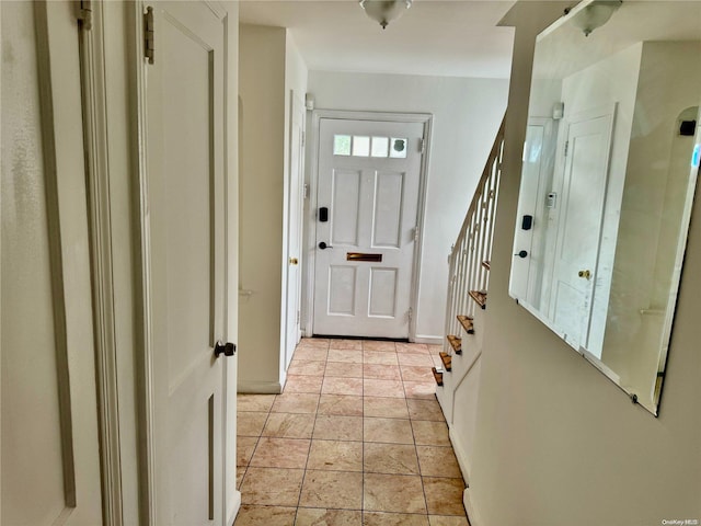 doorway with light tile patterned flooring