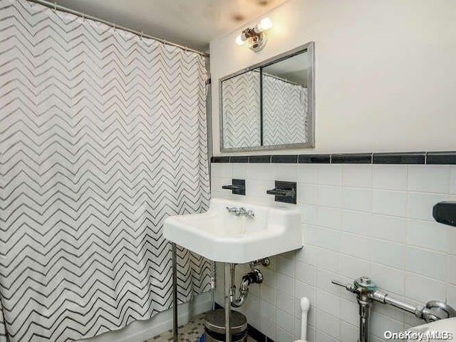 bathroom with tile walls