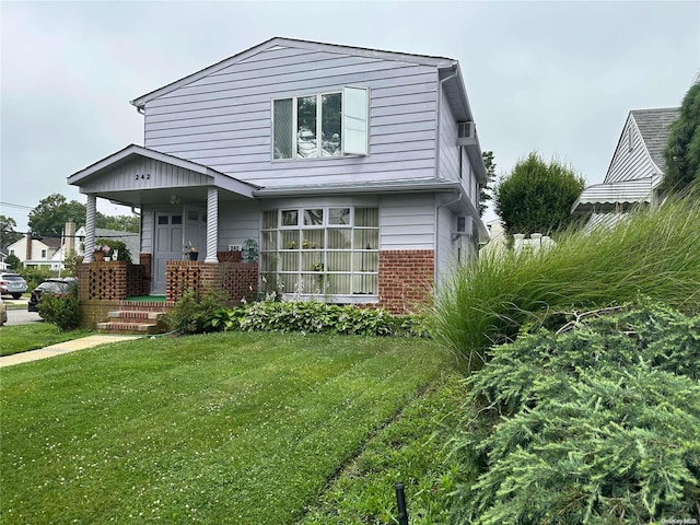 view of front facade with a front lawn and covered porch