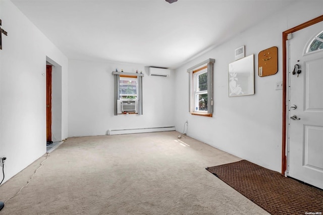 entryway with light carpet, a baseboard radiator, and a wall mounted air conditioner