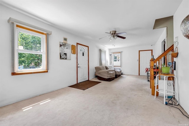 carpeted living room featuring ceiling fan