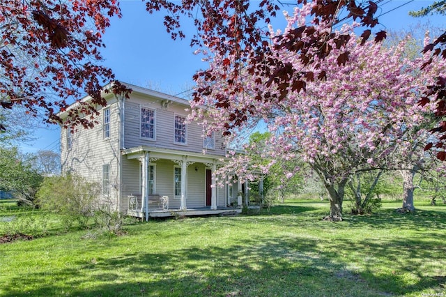 italianate house with a porch and a front lawn