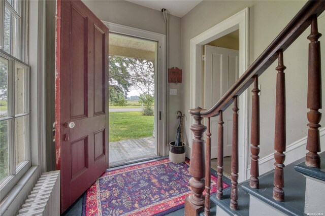 foyer entrance featuring plenty of natural light and radiator heating unit