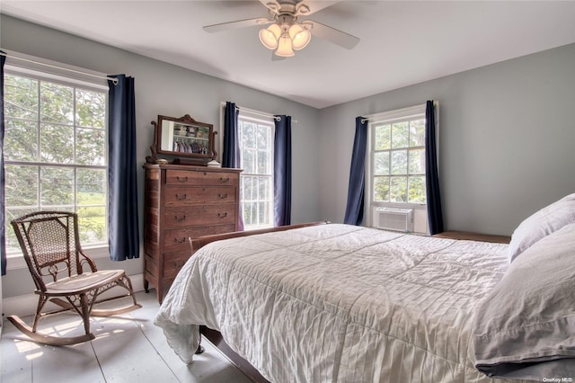 bedroom featuring ceiling fan and cooling unit