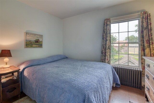 bedroom featuring radiator