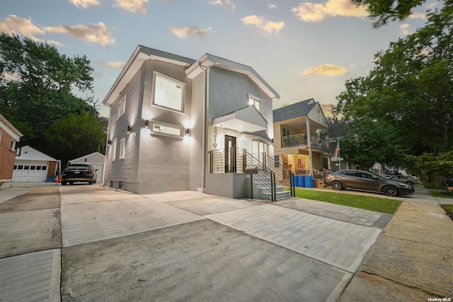 contemporary house with a garage and an outbuilding