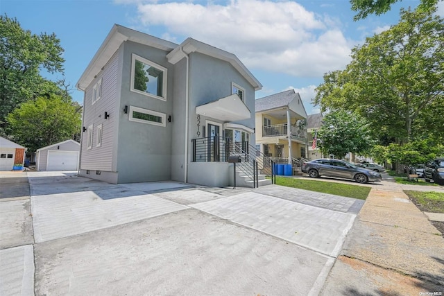 exterior space featuring a garage and an outdoor structure