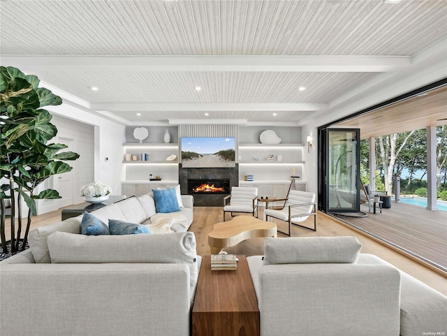 living room featuring beamed ceiling, light hardwood / wood-style flooring, and wood ceiling