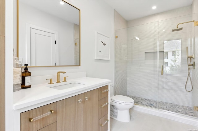 bathroom with vanity, an enclosed shower, and toilet