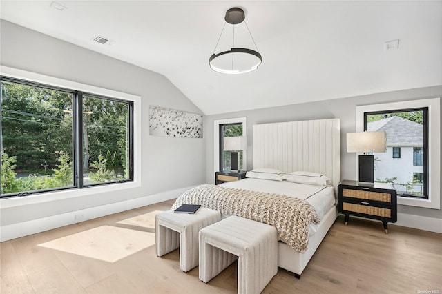 bedroom featuring wood-type flooring and vaulted ceiling