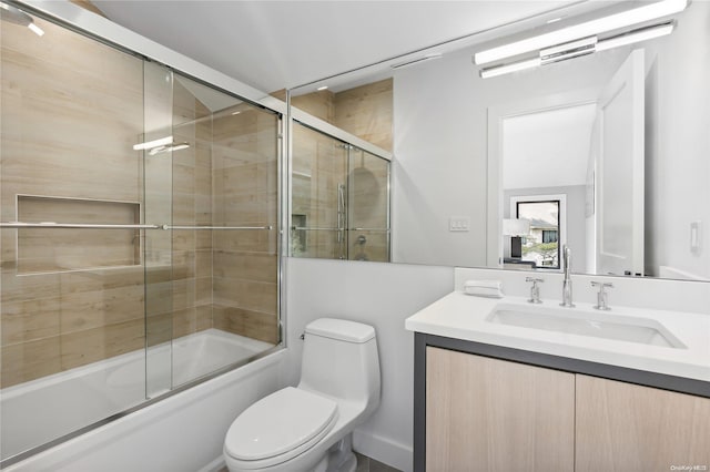 full bathroom with vanity, toilet, and bath / shower combo with glass door