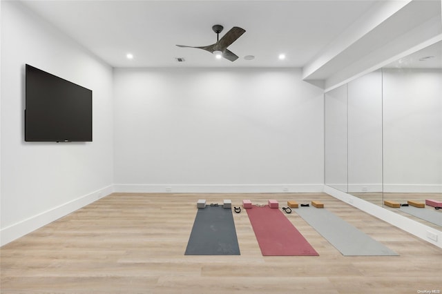 exercise area featuring hardwood / wood-style floors and ceiling fan