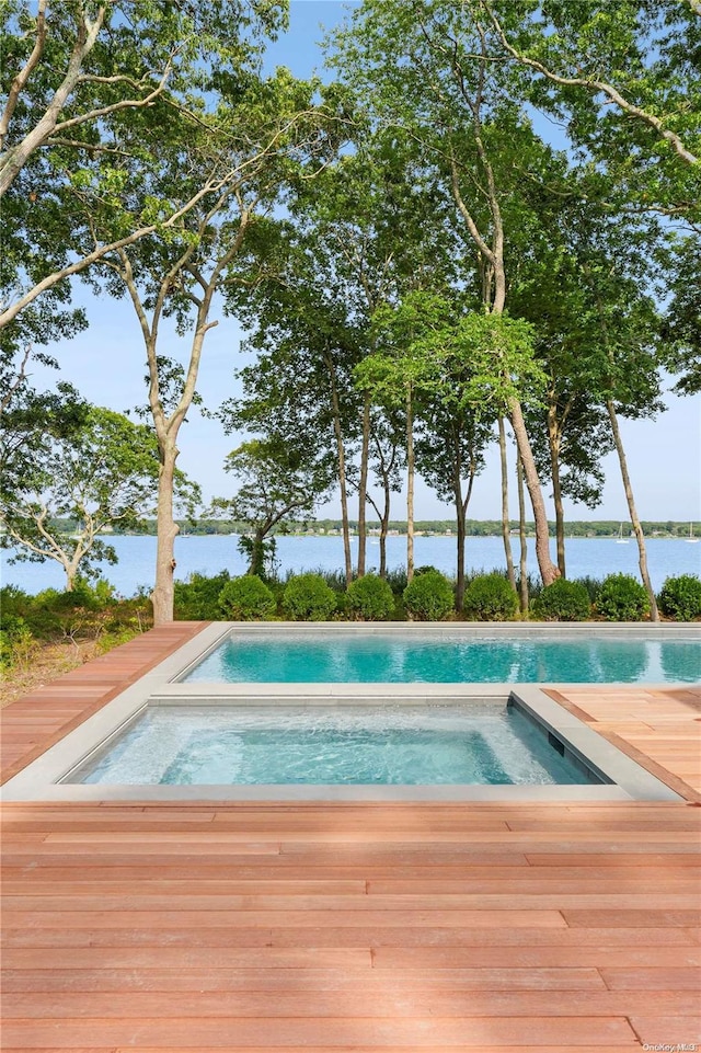 view of swimming pool featuring an in ground hot tub