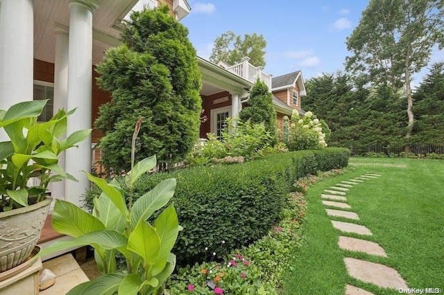 view of yard with a balcony