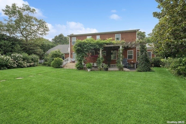 rear view of house with a pergola and a lawn