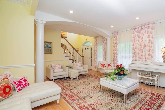 living room with wood-type flooring and ornate columns