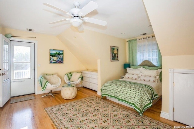 bedroom featuring ceiling fan, light hardwood / wood-style flooring, and lofted ceiling