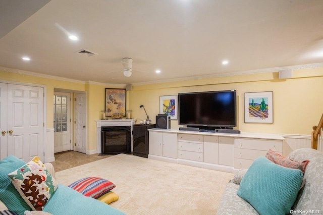 living room with ceiling fan and crown molding