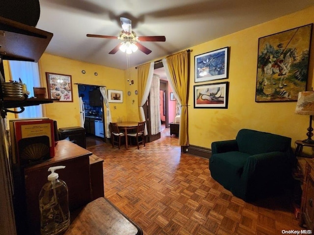 living room with dark parquet flooring and ceiling fan