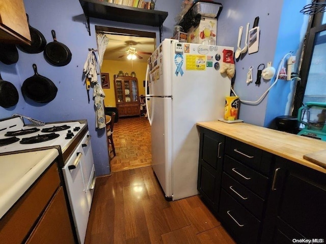 kitchen with dark hardwood / wood-style floors, ceiling fan, white appliances, and wooden counters