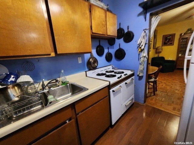 kitchen with dark hardwood / wood-style flooring and electric stove