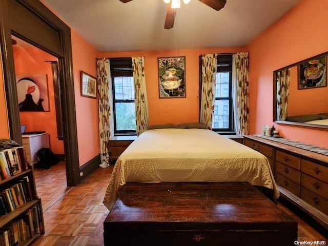 bedroom with ceiling fan and parquet flooring