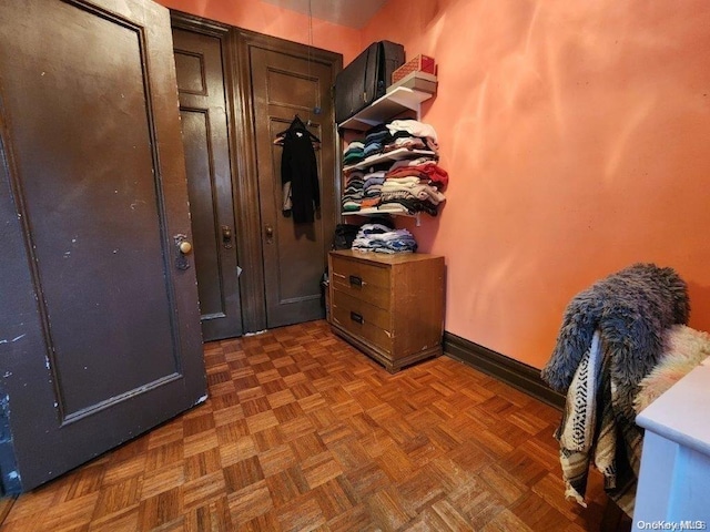 mudroom featuring dark parquet flooring