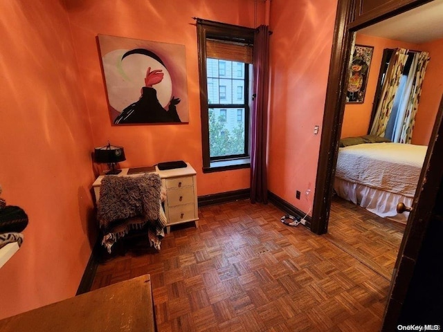 bedroom featuring dark parquet flooring