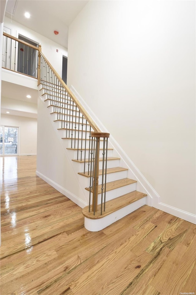 stairs featuring wood-type flooring