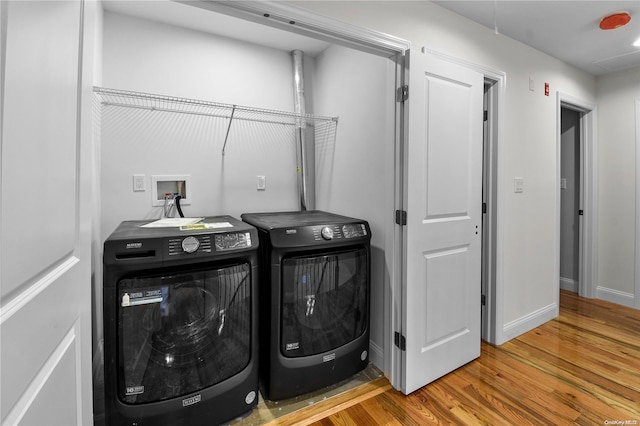 laundry area featuring hardwood / wood-style floors and independent washer and dryer