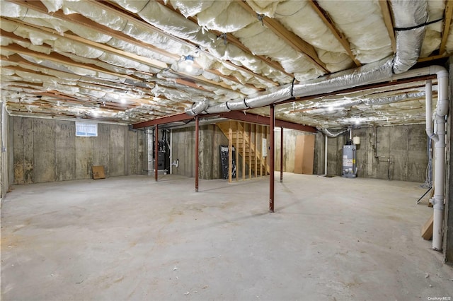 basement featuring gas water heater and heating unit