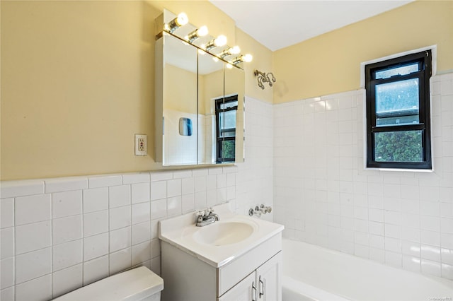 full bathroom featuring vanity, toilet, tile walls, and tub / shower combination