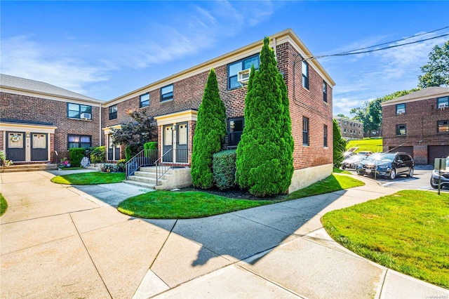 view of property featuring a front lawn