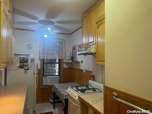 kitchen with ceiling fan, tile counters, refrigerator, light tile patterned flooring, and white gas range oven